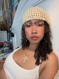 a woman with curly hair laying on a bed